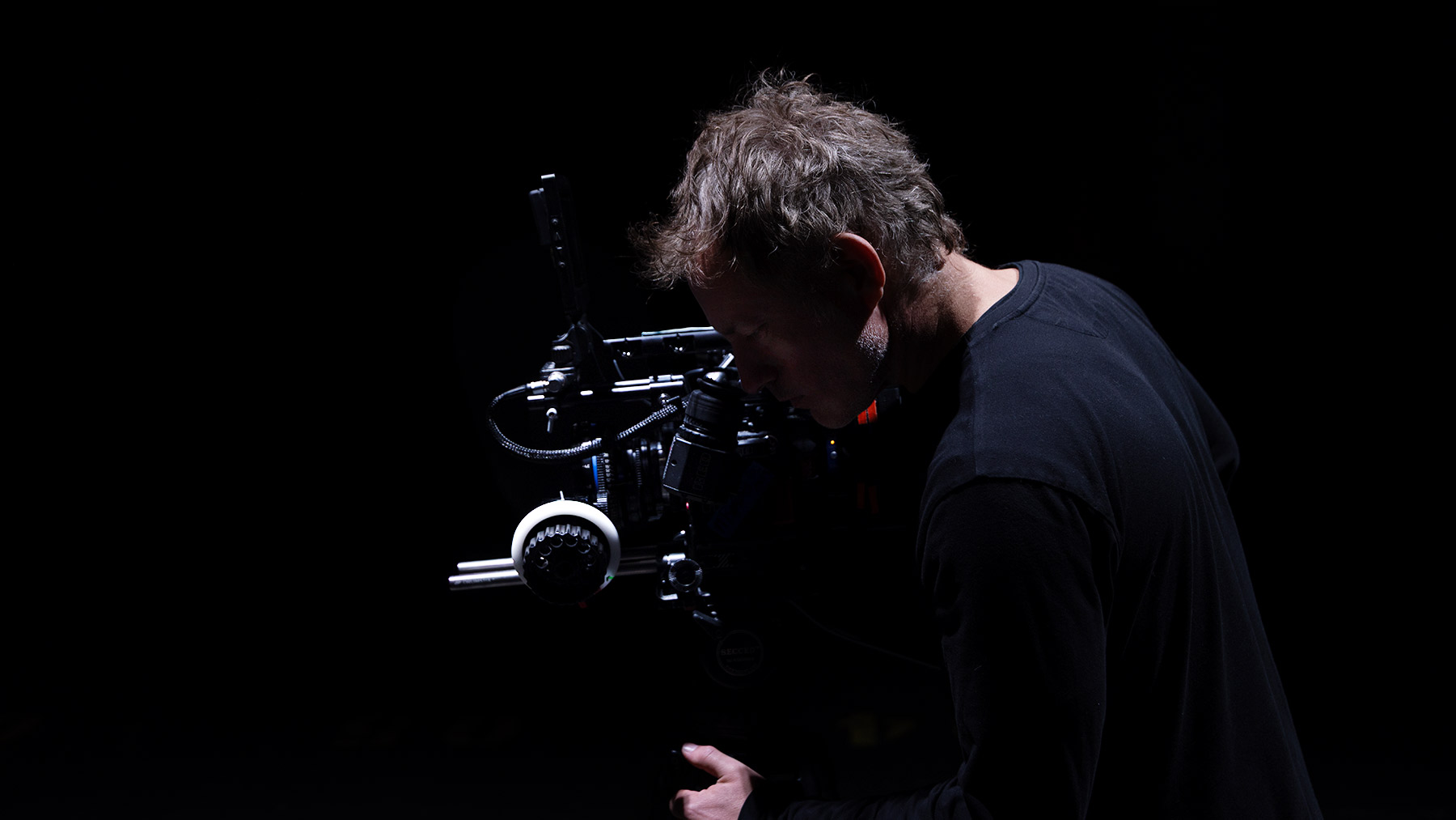 Joshua Michael Shelton directing on a film set with a cinema camera